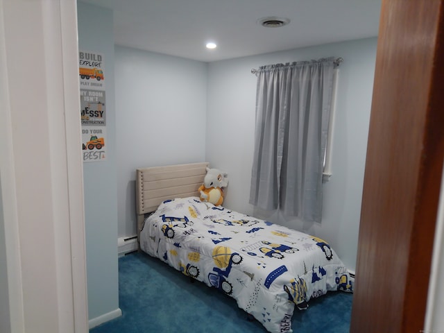 carpeted bedroom with a baseboard heating unit