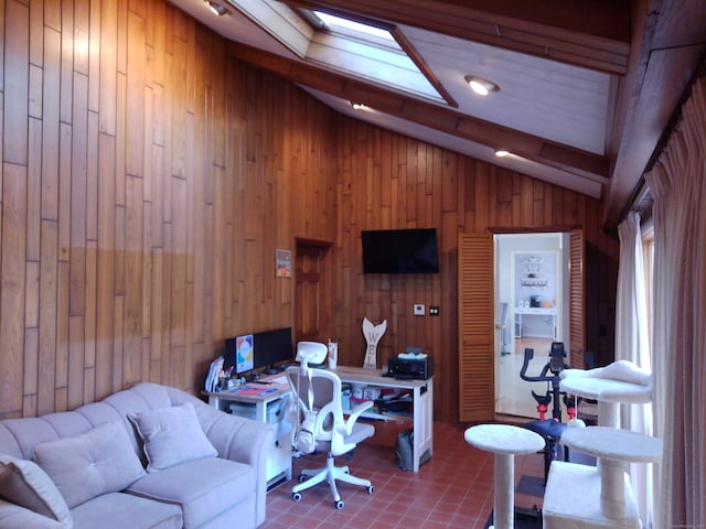 office area featuring lofted ceiling with skylight and wood walls