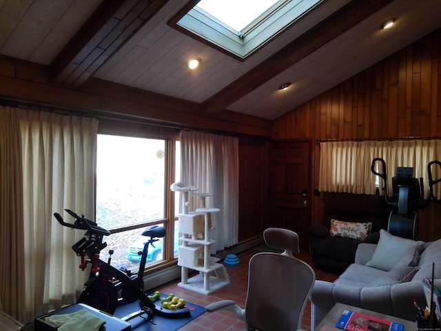 living room featuring wood walls, vaulted ceiling with skylight, and tile patterned floors