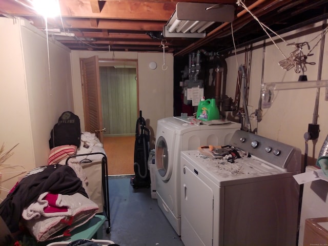 clothes washing area with separate washer and dryer