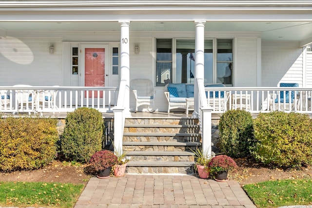 view of exterior entry with a porch