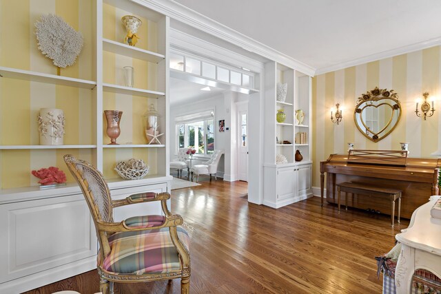 10 Island View Ave, Branford, CT 06405 - living area with built in shelves, wood finished floors, crown molding, wallpapered walls, and baseboards