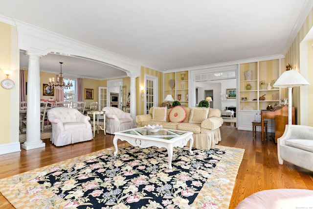 living room featuring ornamental molding, decorative columns, and hardwood / wood-style floors