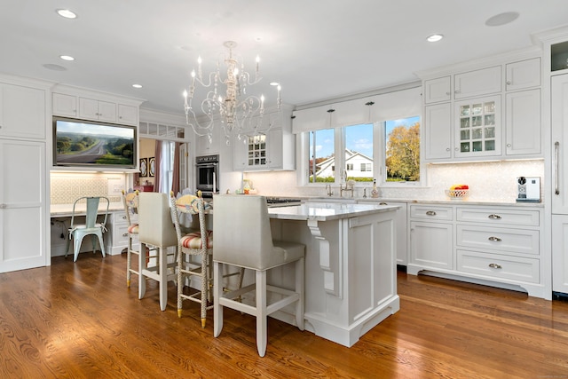 10 Island View Ave, Branford, CT 06405 - kitchen featuring stainless steel oven, a chandelier, a center island, and white cabinetry