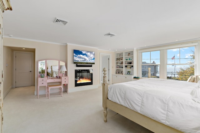 bedroom with crown molding and light colored carpet