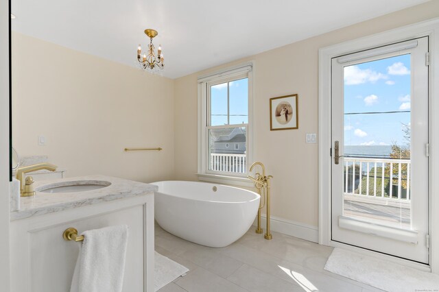 10 Island View Ave, Branford, CT 06405 - bathroom featuring vanity, a notable chandelier, a freestanding tub, and plenty of natural light