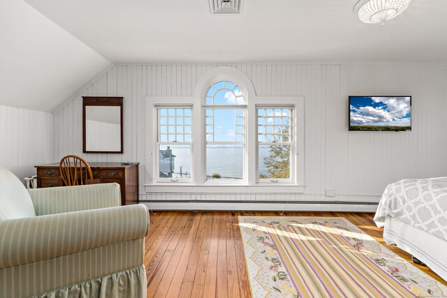 bedroom featuring lofted ceiling and light hardwood / wood-style flooring