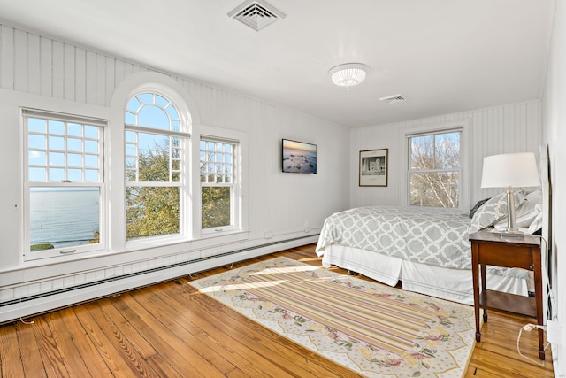 10 Island View Ave, Branford, CT 06405 - bedroom with visible vents, multiple windows, wood-type flooring, and a baseboard radiator