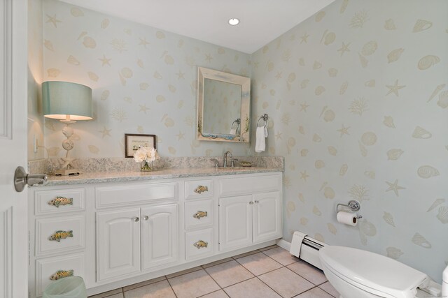 bathroom with vanity, toilet, tile patterned flooring, and a baseboard heating unit