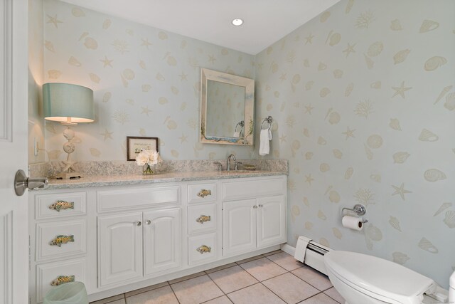 10 Island View Ave, Branford, CT 06405 - bathroom with tile patterned floors, toilet, a sink, a baseboard heating unit, and double vanity