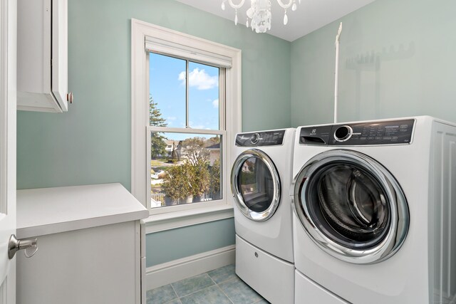 10 Island View Ave, Branford, CT 06405 - washroom with tile patterned floors, cabinet space, an inviting chandelier, baseboards, and washing machine and clothes dryer