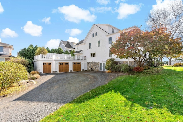 10 Island View Ave, Branford, CT 06405 - view of front of home featuring a front lawn, an attached garage, stone siding, and driveway