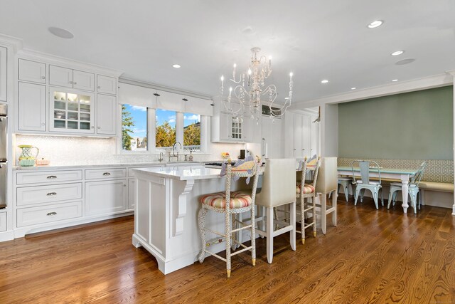 10 Island View Ave, Branford, CT 06405 - kitchen featuring an inviting chandelier, wood finished floors, a center island, and white cabinetry