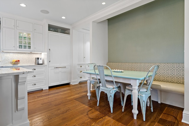 dining space featuring breakfast area and dark wood-type flooring