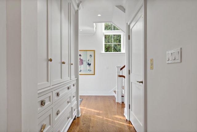 hall featuring lofted ceiling and light wood-type flooring