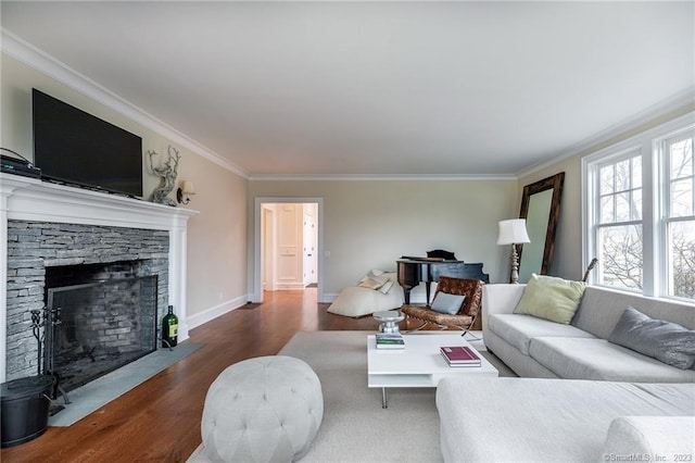 living room featuring a stone fireplace, ornamental molding, and dark hardwood / wood-style floors