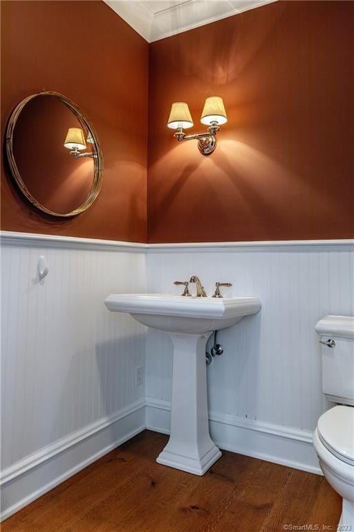 bathroom with wood-type flooring and toilet