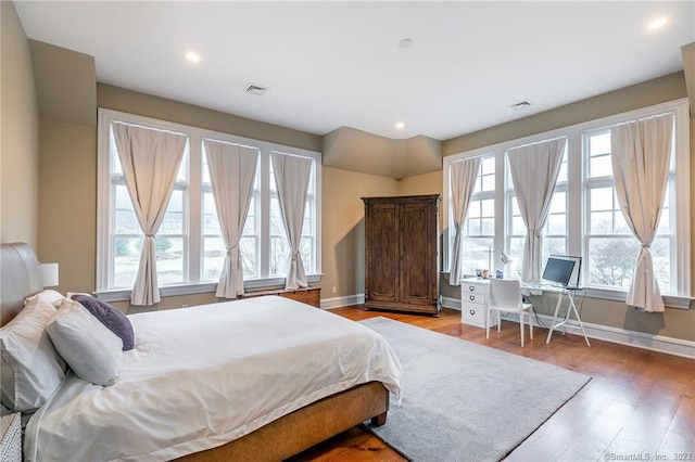 bedroom featuring multiple windows and light wood-type flooring