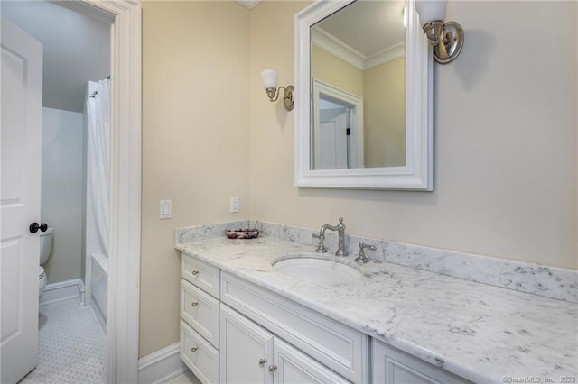 bathroom featuring vanity, crown molding, toilet, and tile patterned flooring