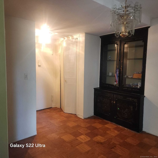 hallway featuring a notable chandelier