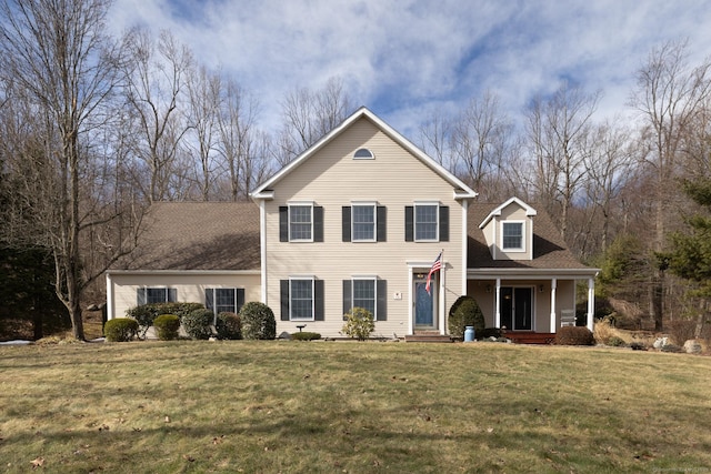 traditional-style home featuring a front yard and a porch