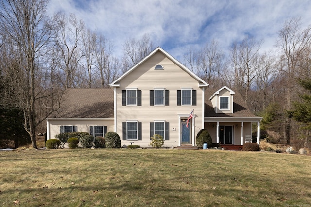 traditional-style house with covered porch and a front yard