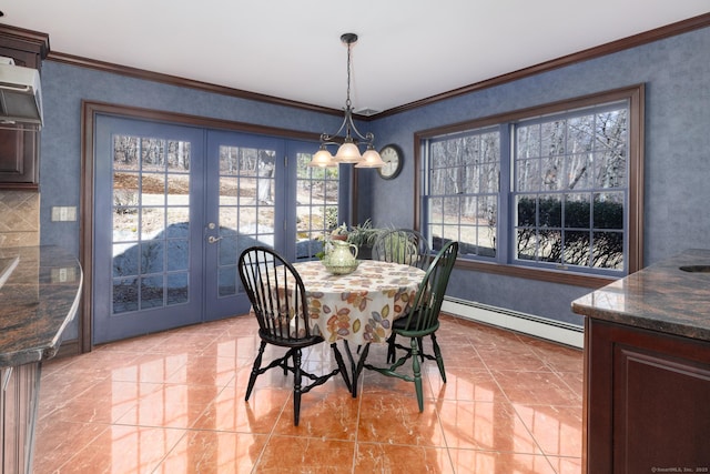 dining area featuring a baseboard heating unit, crown molding, and french doors