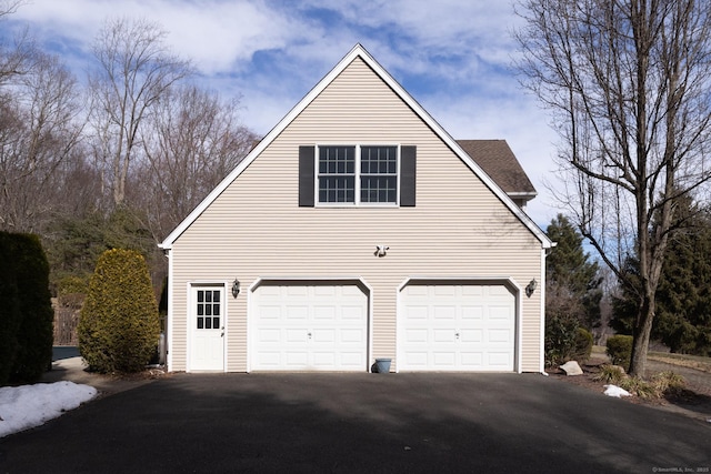 garage featuring aphalt driveway