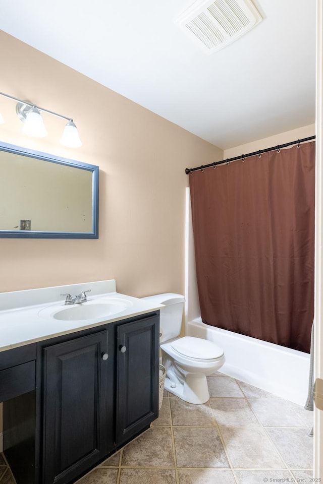 bathroom featuring vanity, visible vents, tile patterned flooring, shower / bath combo with shower curtain, and toilet