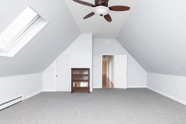 additional living space featuring a baseboard radiator, ceiling fan, baseboards, and carpet flooring