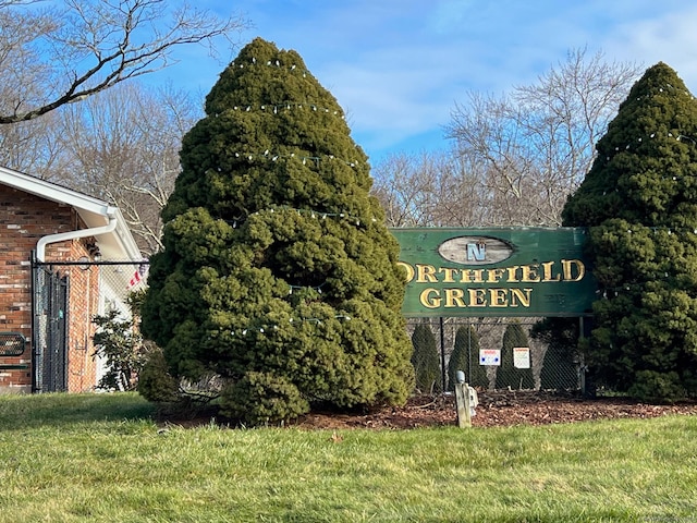 community / neighborhood sign with a yard