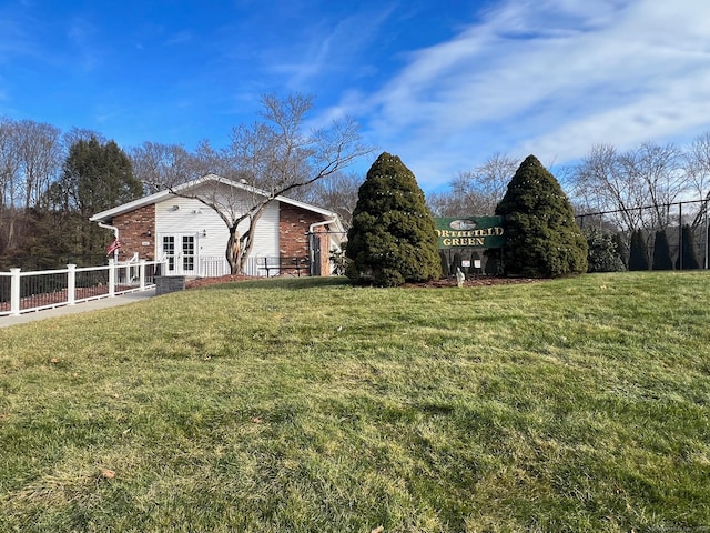 view of side of property with a lawn