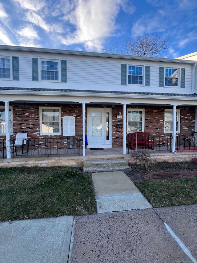 townhome / multi-family property featuring a porch