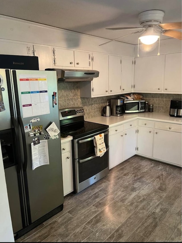 kitchen with ventilation hood, white cabinets, dark hardwood / wood-style floors, and stainless steel appliances