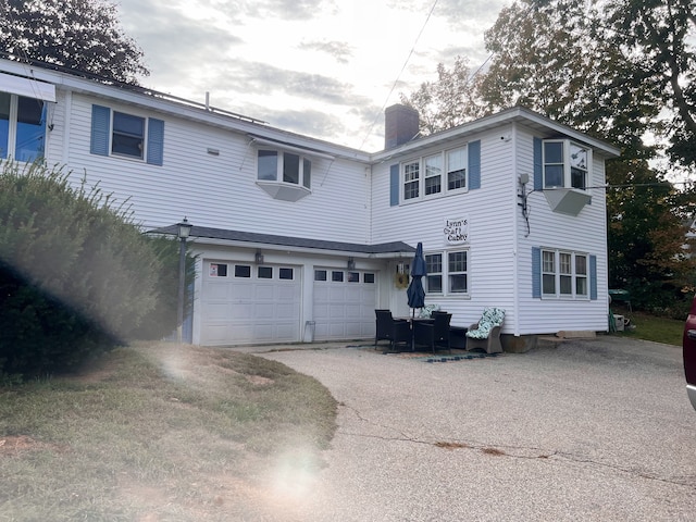 back of property featuring a garage