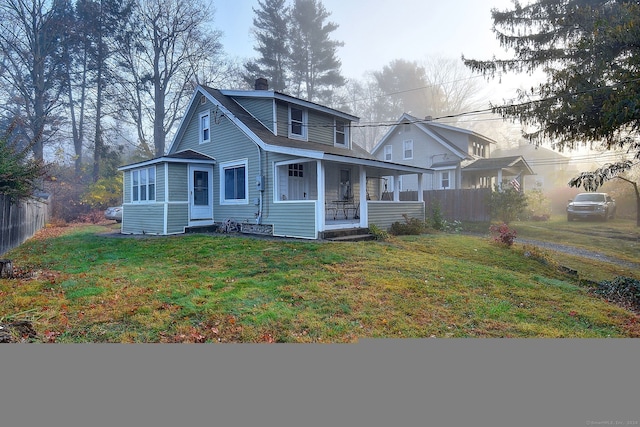 view of front of home featuring a front yard and a porch