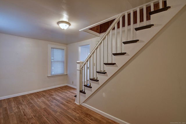 stairs with hardwood / wood-style floors