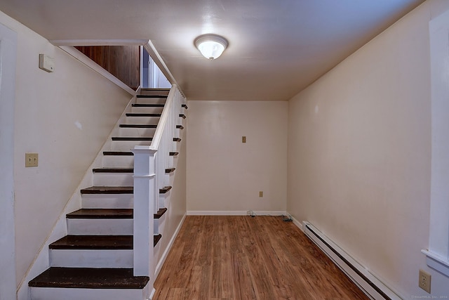 basement with baseboard heating and wood-type flooring