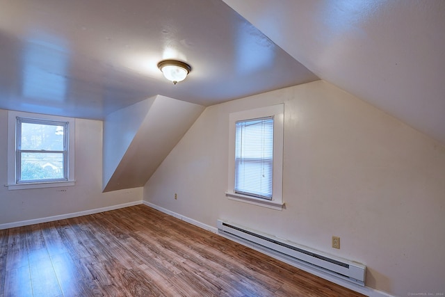 bonus room featuring wood-type flooring, lofted ceiling, and baseboard heating