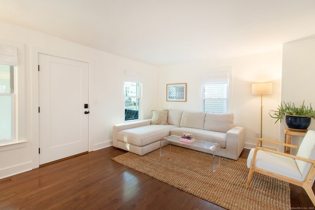 living room featuring plenty of natural light and dark hardwood / wood-style floors