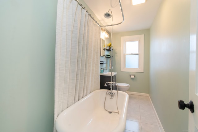 bathroom featuring tile patterned flooring, vanity, a bathtub, and toilet