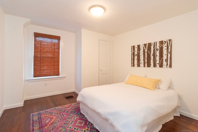 bedroom featuring dark hardwood / wood-style flooring