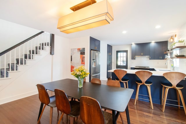 dining space with sink and dark hardwood / wood-style flooring