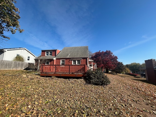 rear view of property featuring a deck