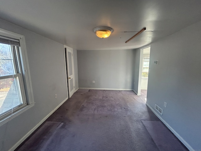 carpeted empty room with a wealth of natural light