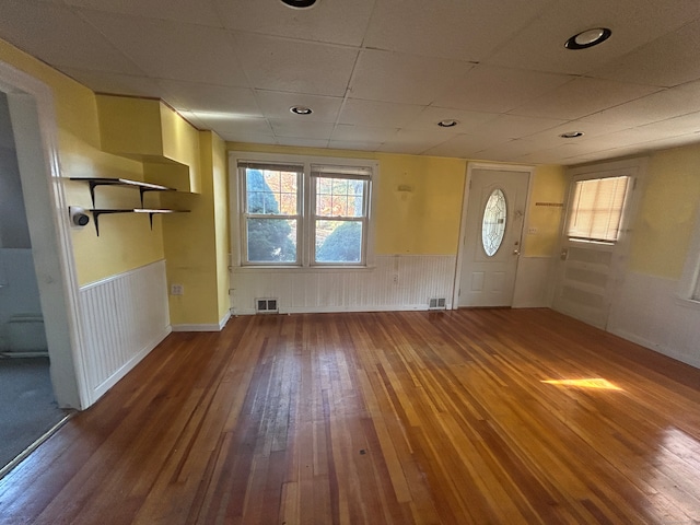 entrance foyer featuring hardwood / wood-style floors, a paneled ceiling, and a healthy amount of sunlight