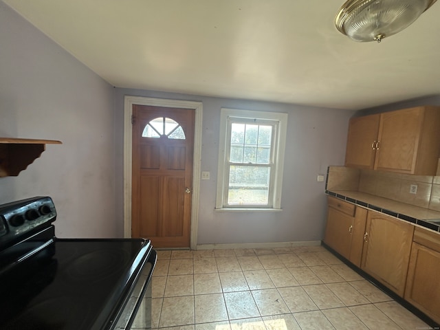 kitchen featuring tile counters and electric range