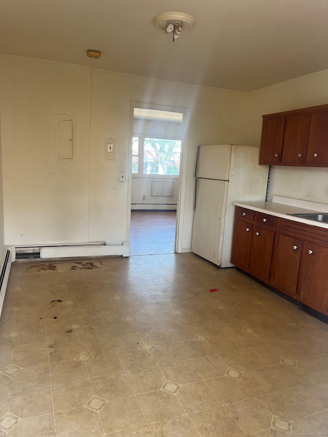 kitchen featuring sink, white refrigerator, and a baseboard heating unit