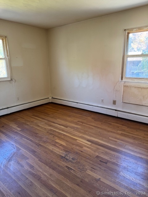 unfurnished room with dark wood-type flooring and a healthy amount of sunlight