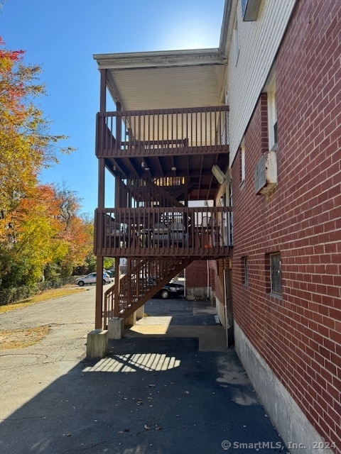 view of side of home with a wooden deck